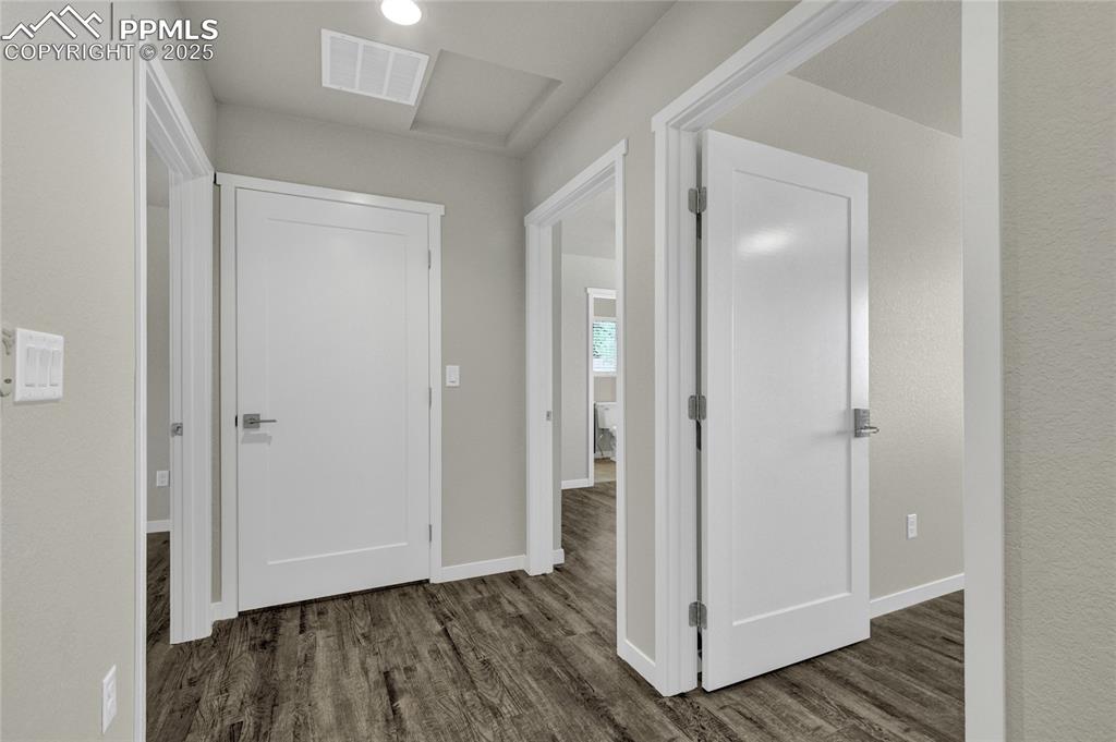 Image 22 of 38: Hall featuring dark wood finished floors and baseboards