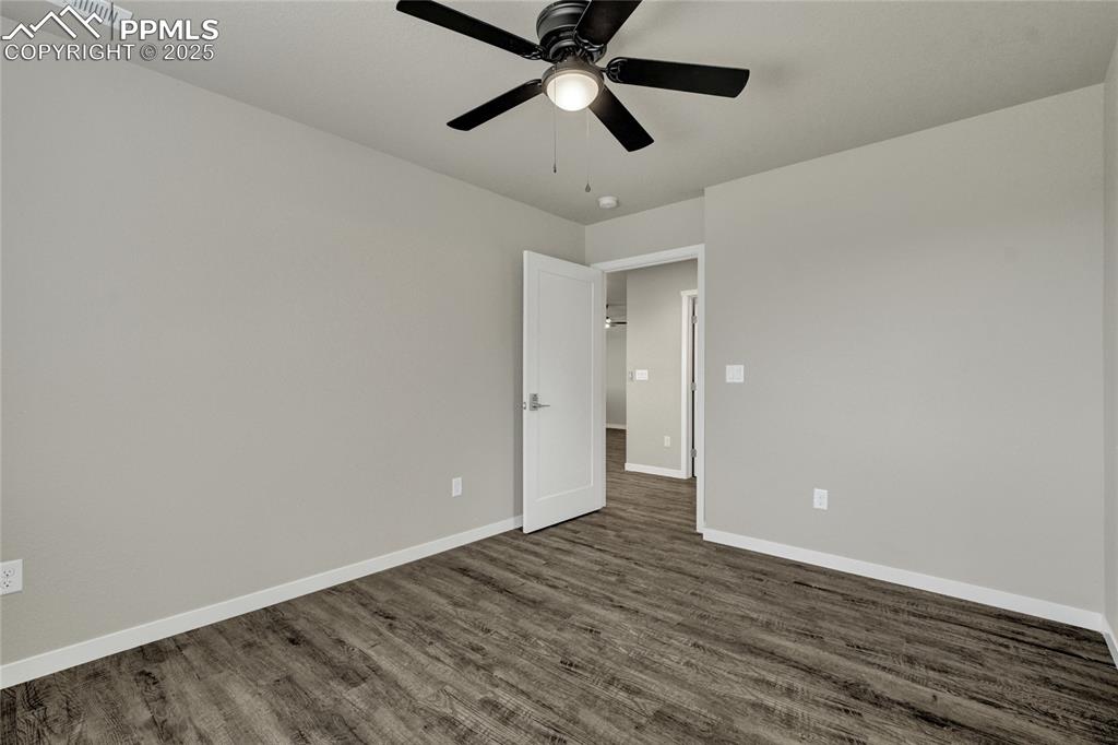 Image 29 of 38: Bedroom featuring dark wood-style floors and ceiling fan