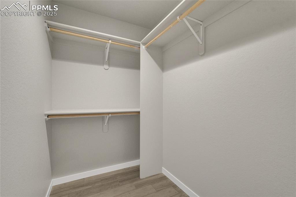 Image 31 of 38: Spacious closet with light wood-style flooring