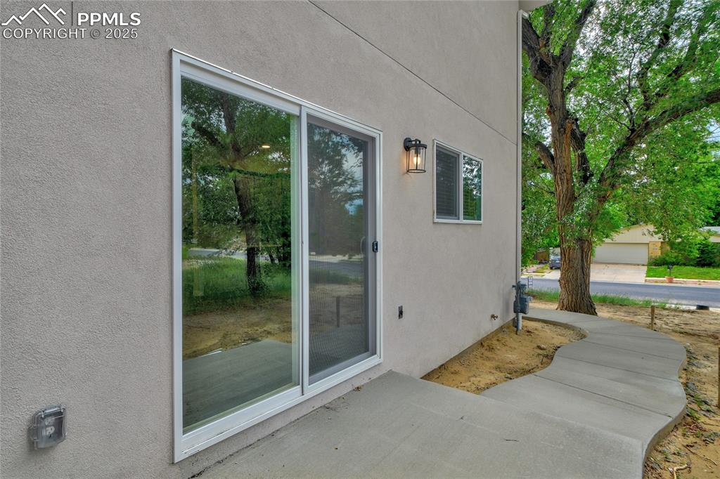 Image 37 of 38: View of exterior entry with stucco siding