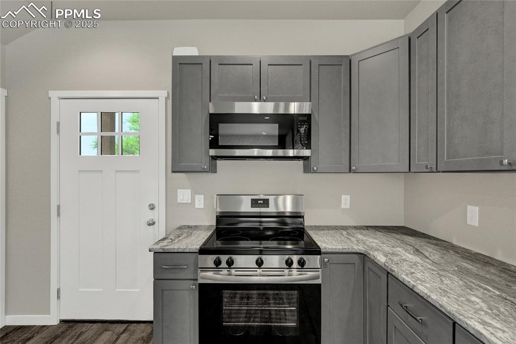 Image 6 of 38: Kitchen featuring gray cabinets, appliances with stainless steel finishes, 