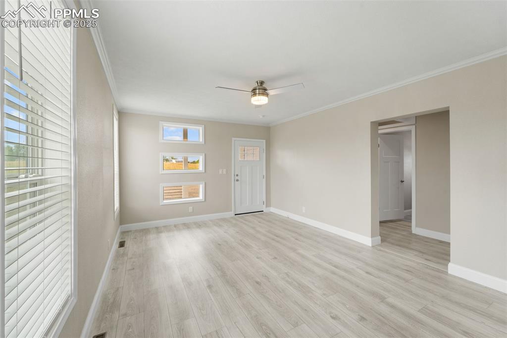 Image 12 of 44: Spare room featuring ornamental molding, light wood-style floors, and ceili