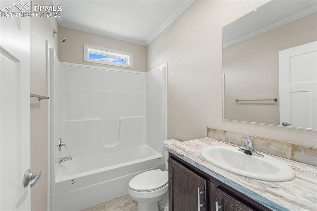 Image 28 of 44: Full bathroom with crown molding, vanity, and bathtub / shower combination