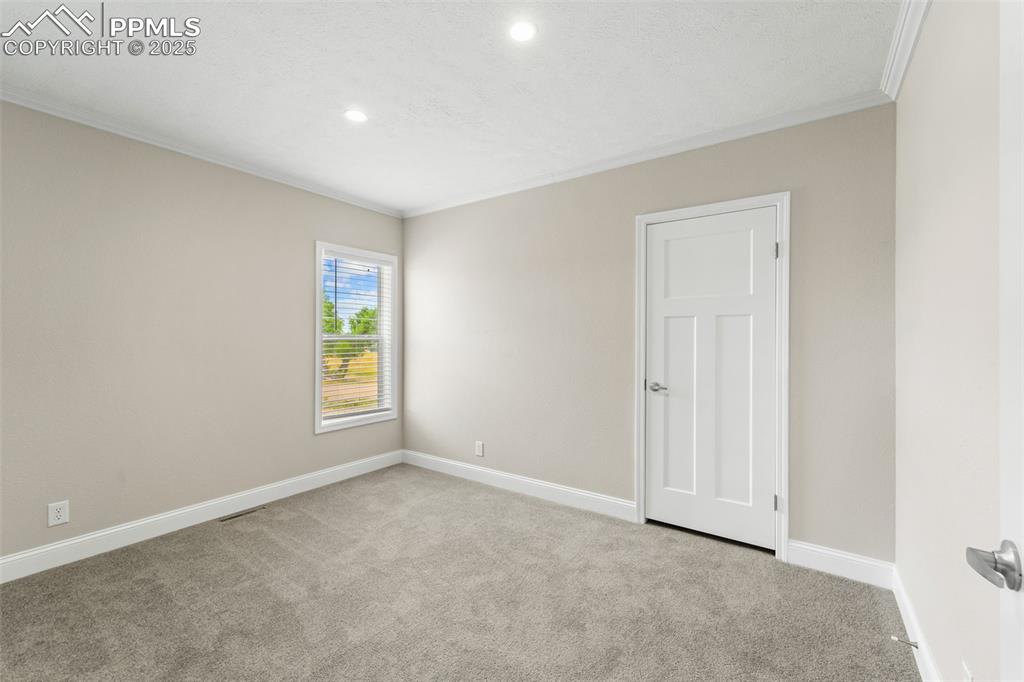 Image 30 of 44: Empty room featuring ornamental molding, carpet, and recessed lighting