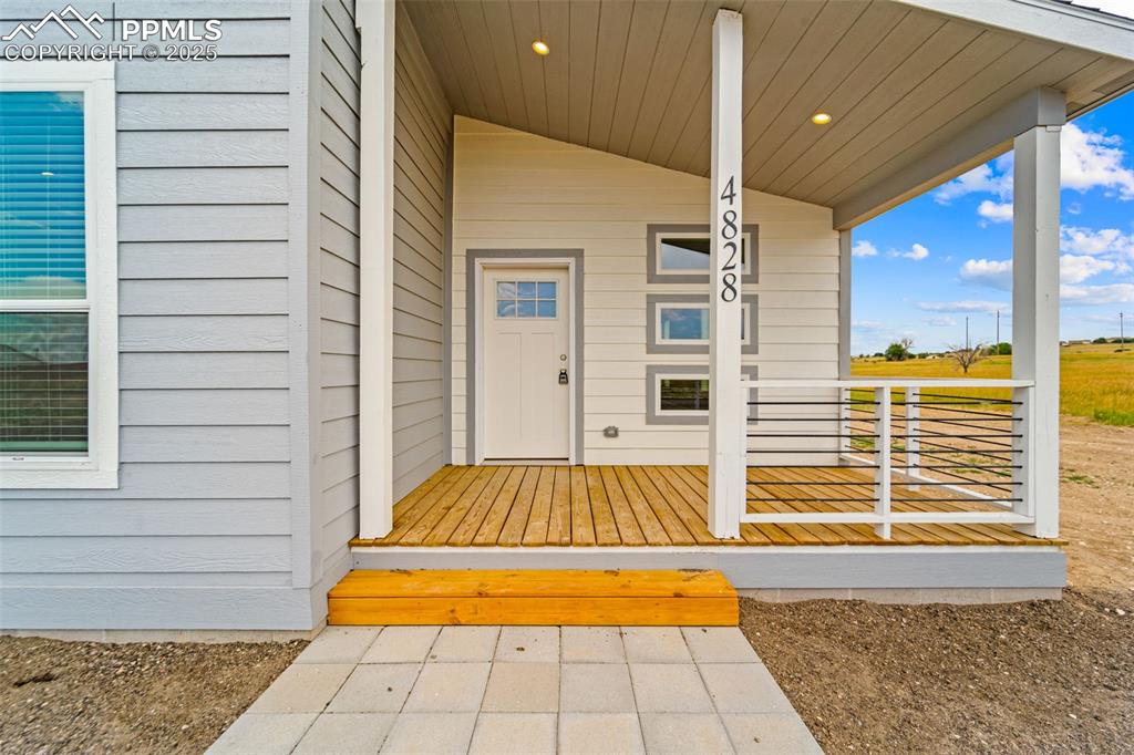 Image 5 of 44: Doorway to property featuring a porch
