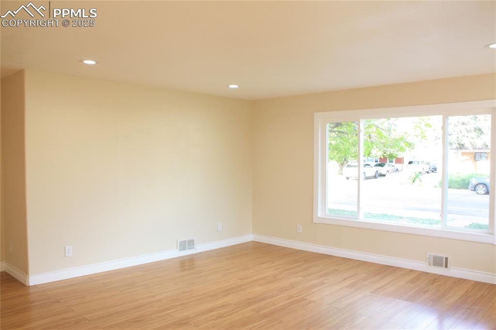 Image 13 of 42: Unfurnished room with light wood-style floors, recessed lighting, and baseb
