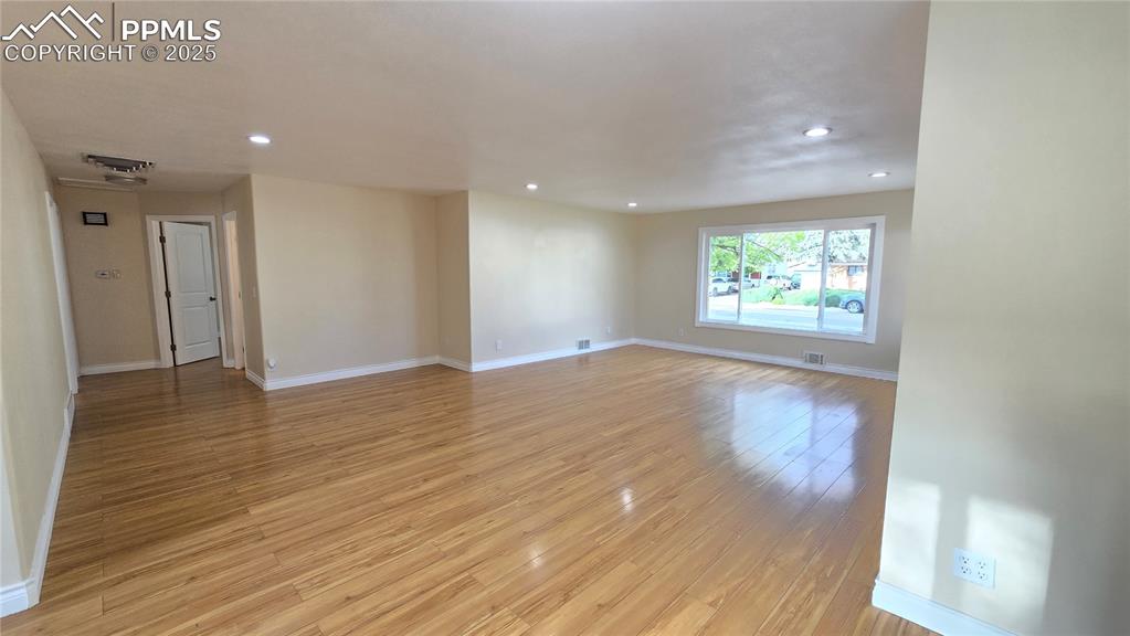 Image 2 of 42: Living room featuring recessed lighting, light wood-type flooring, and base