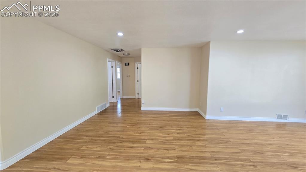 Image 3 of 42: Living room with recessed lighting, light wood finished floors, and baseboa