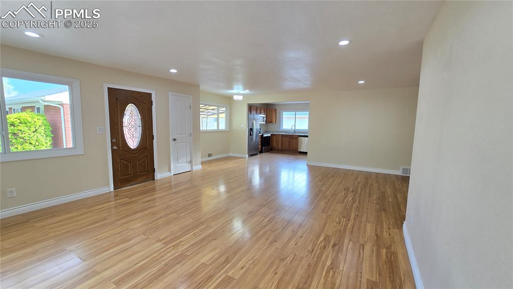 Image 4 of 42: Entrance foyer with light wood-style floors, recessed lighting, and baseboa