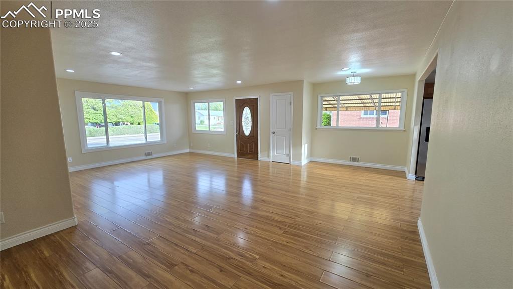 Image 7 of 42: Foyer with baseboards, wood-type flooring, and recessed lighting
