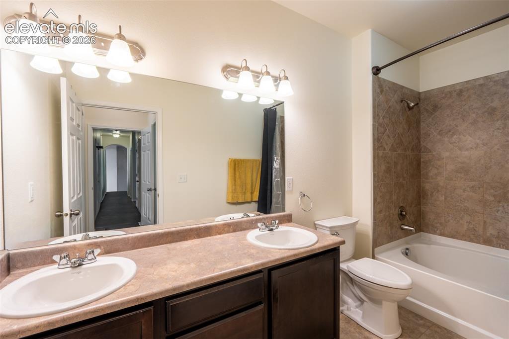 Image 14 of 26: Primary full bathroom (1) with dual sinks