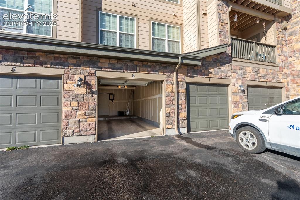 Image 2 of 26: Oversized and attached garage (number 6) and reserved space in front