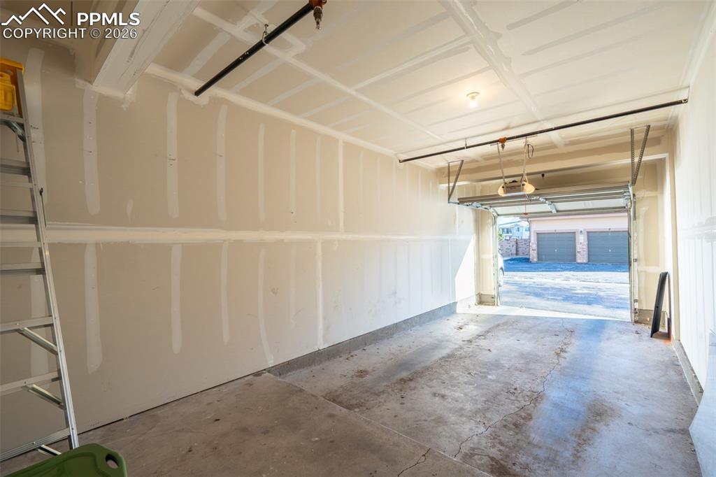 Image 22 of 26: Oversized and attached garage (number 6) and reserved space in front