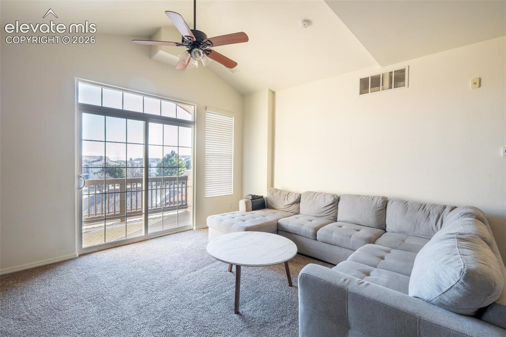Image 5 of 26: Living room with walk out covered balcony