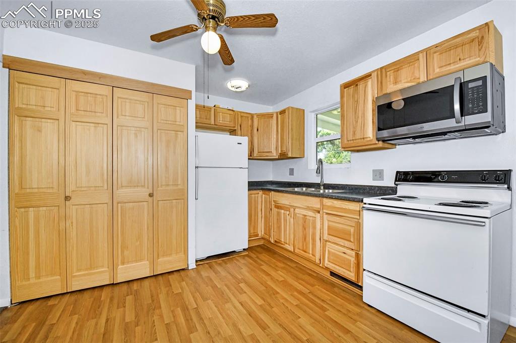 Image 6 of 19: Hidden laundry behind cabinets...