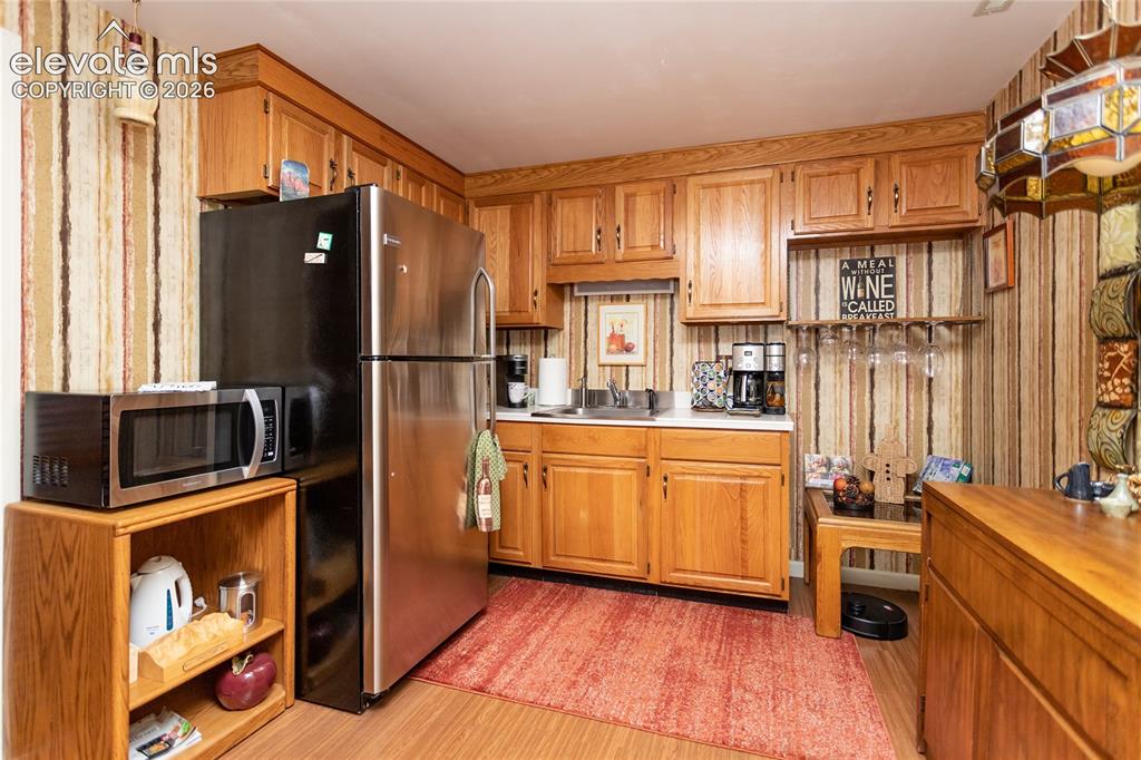 Image 33 of 50: Kitchen in basement. Range hookup also.