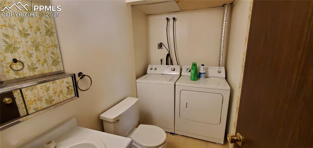 Image 3 of 7: Bathroom with washing machine and dryer and vanity