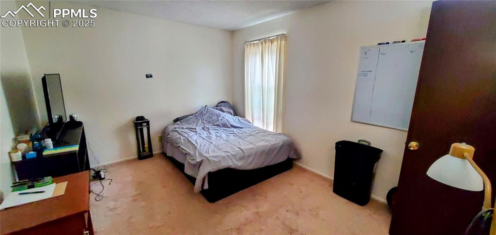 Image 4 of 7: Carpeted bedroom with baseboards