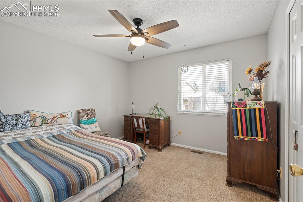 Image 13 of 27: Secondary bedroom on main. Lots of light.