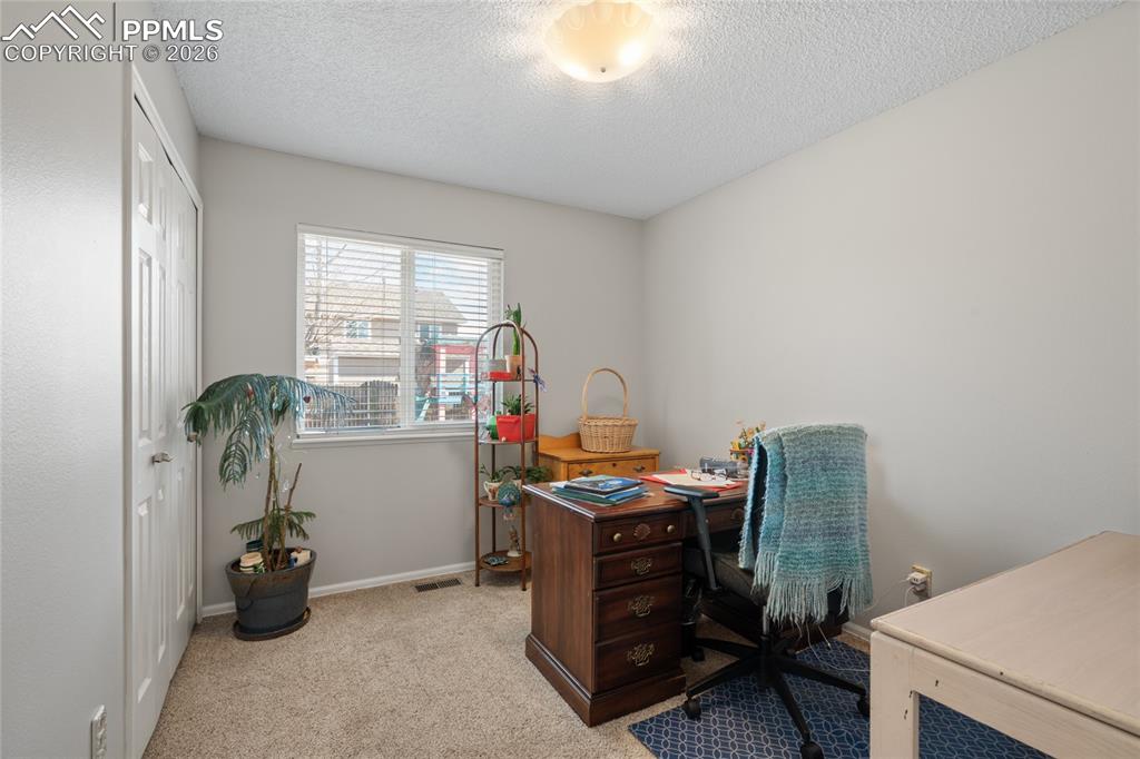 Image 14 of 27: Office or secondary bedroom on main level.