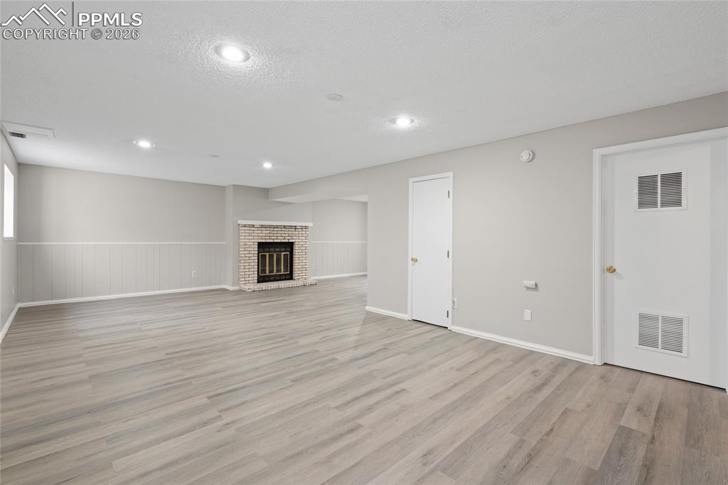 Image 18 of 27: Cozy wood burning fireplace.