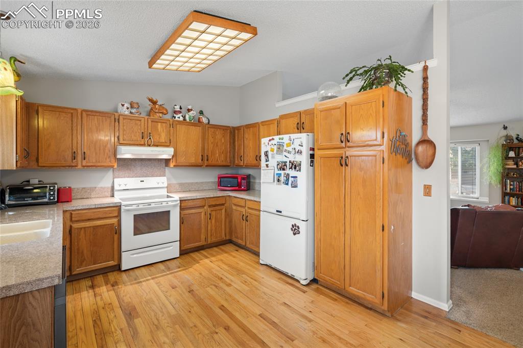 Image 7 of 27: The kitchen has a convenient pantry cabinet.