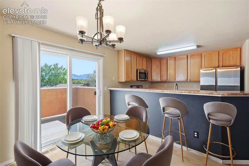 Image 12 of 48: Virtually Staged - Walk-out Dining Space to Decking