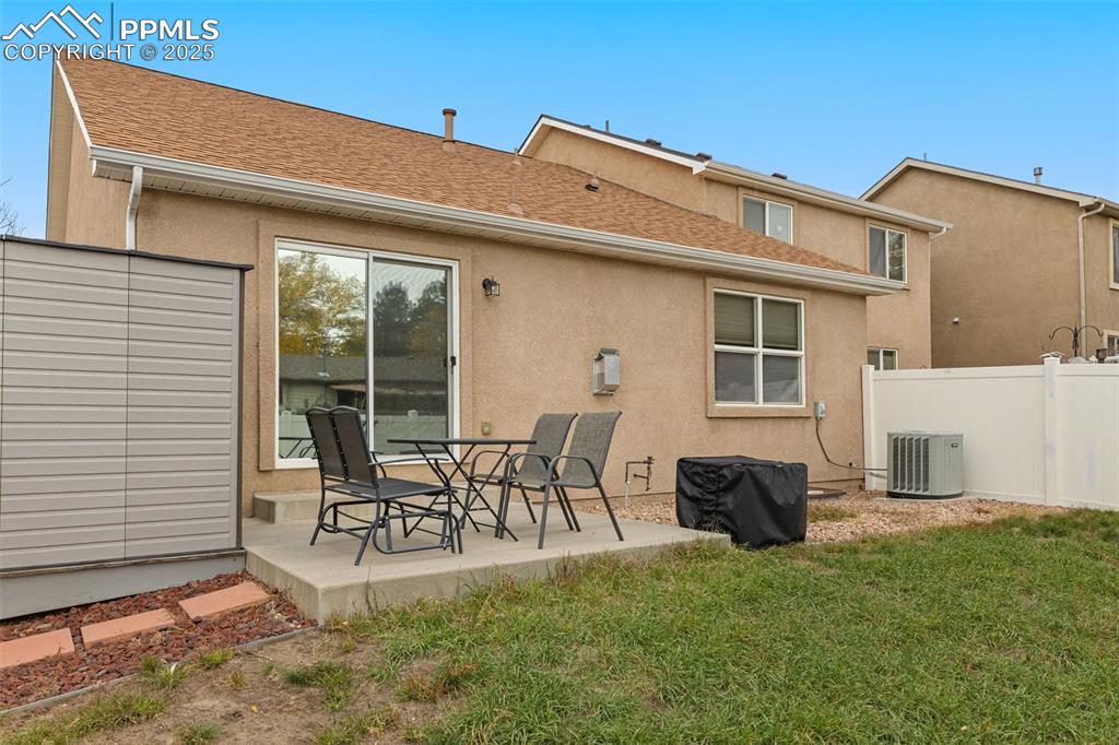 Image 24 of 27: Rear view of property with stucco siding, a patio, and roof with shingles
