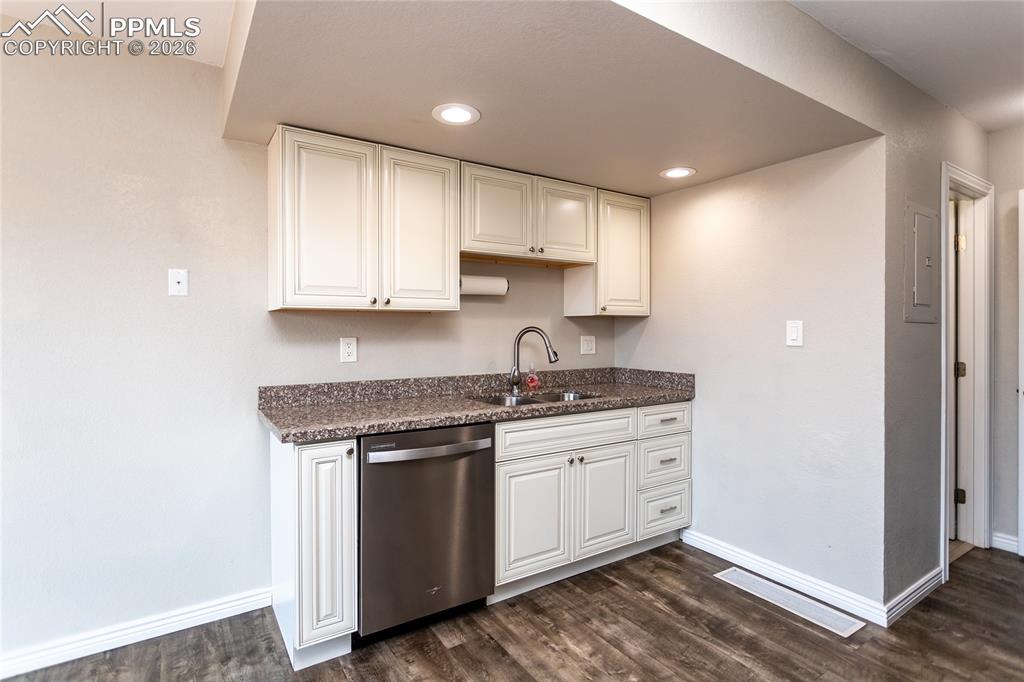 Image 12 of 32: main level half bathroom is just off the kitchen