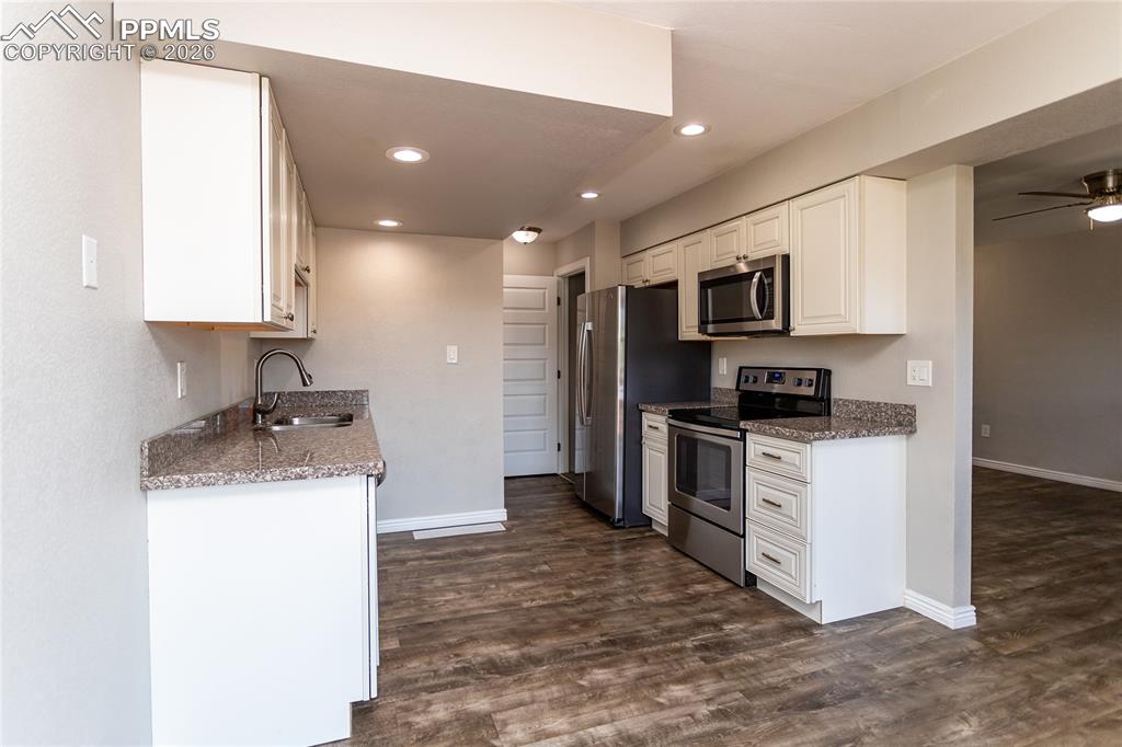 Image 13 of 32: Door to basement level is just off the kitchen