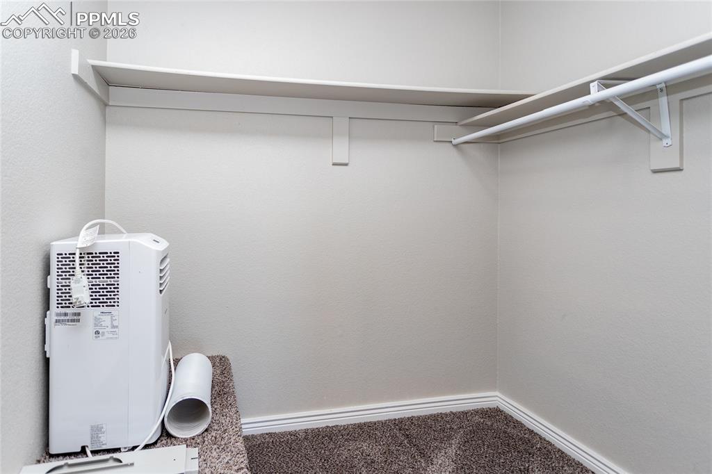 Image 19 of 32: Primary bedroom walk-in closet