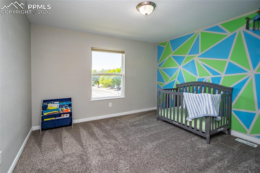 Image 21 of 32: Second bedroom located on upper level with Primary bedroom