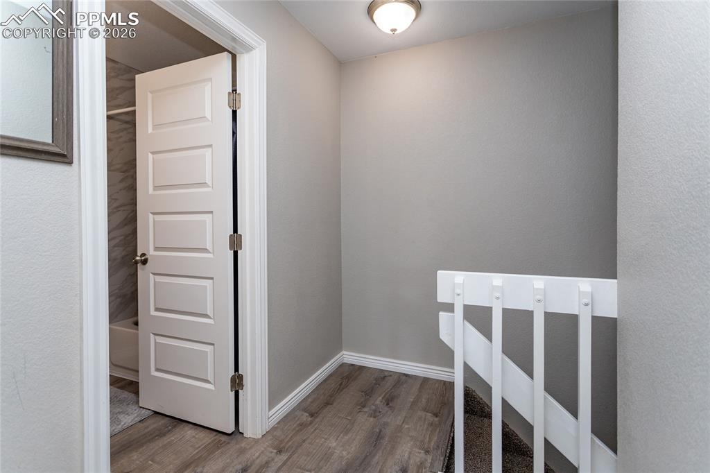 Image 26 of 32: Upstairs hallway to bathroom