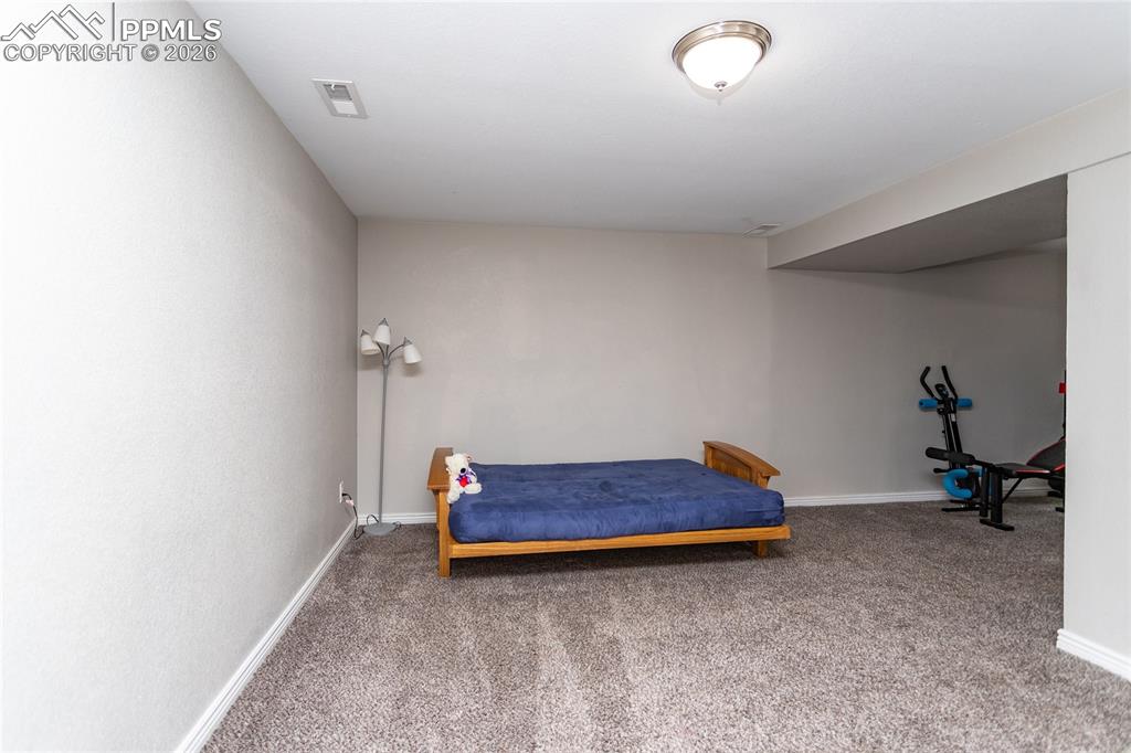 Image 29 of 32: Large third bedroom is located on the basement level