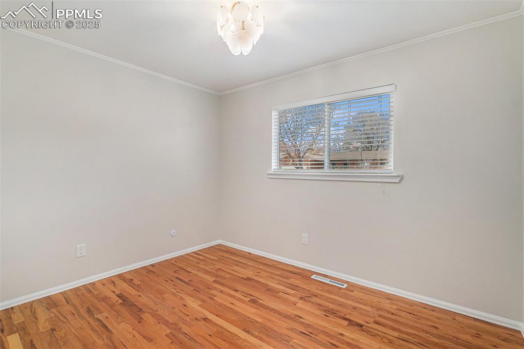 Image 11 of 26: Second Larger Bedroom on Main Upper Level with Oak Hardwood Floors!