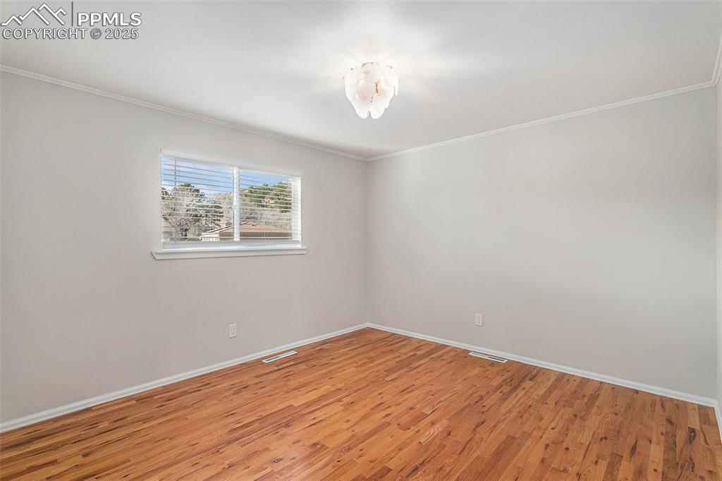 Image 12 of 26: Third Bedroom on Main Upper Level, again with Beautiful Oak Hardwood Floor!