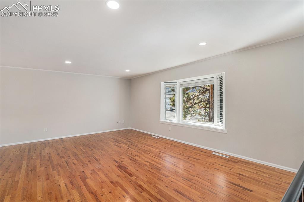Image 5 of 26: LARGE Living Room with Oak Hardwood Floors and Bay Window with Views to Pal