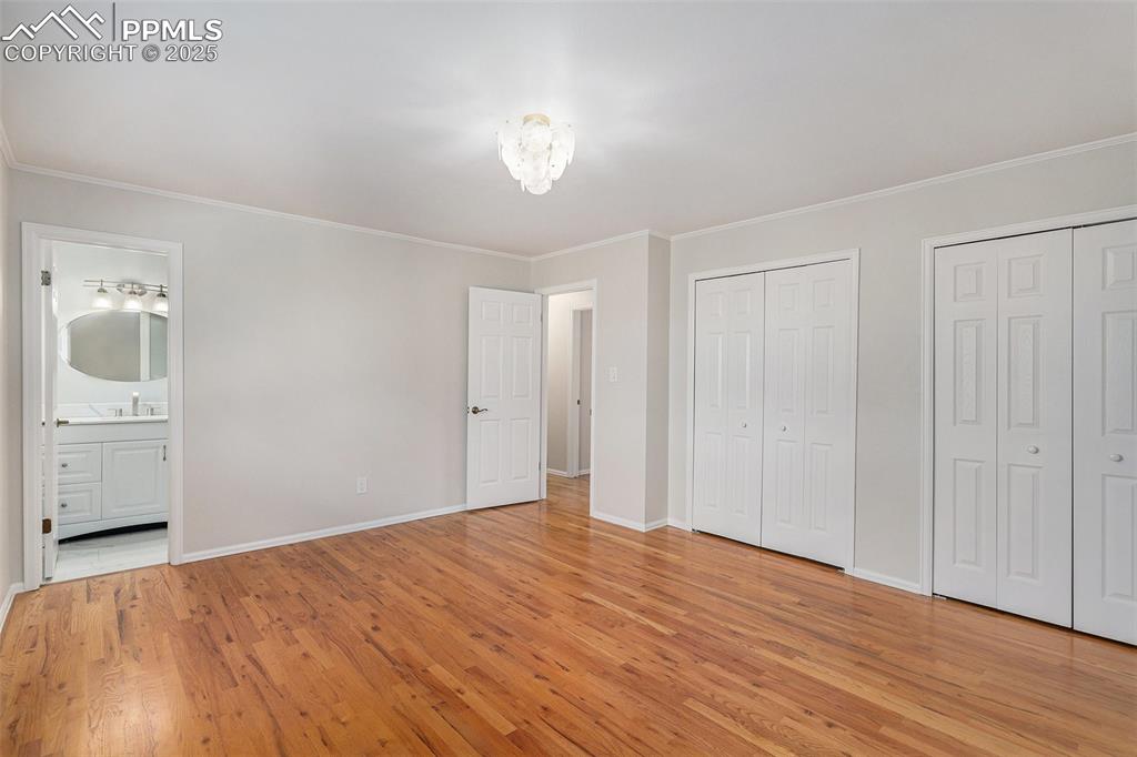 Image 9 of 26: Primary Bedroom Suite with Beautiful Oak Hardwood Floors and Double Closets
