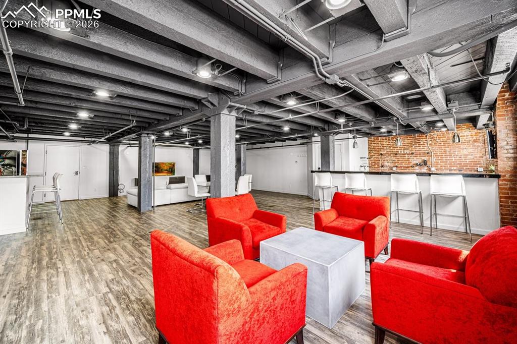 Image 10 of 32: featuring brick wall and wood finished floors