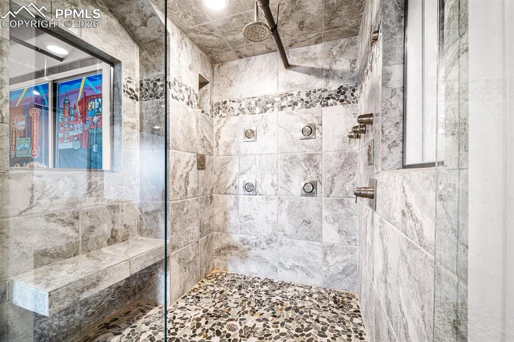 Image 25 of 32: Bathroom featuring a tile shower
