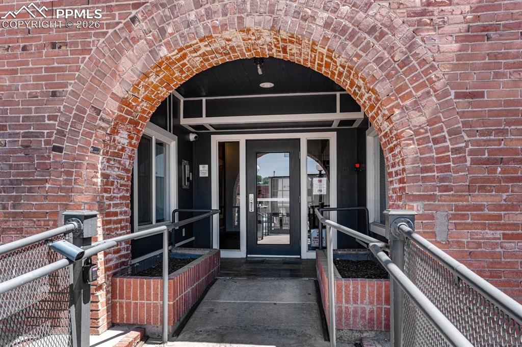 Image 30 of 32: Property entrance featuring brick siding