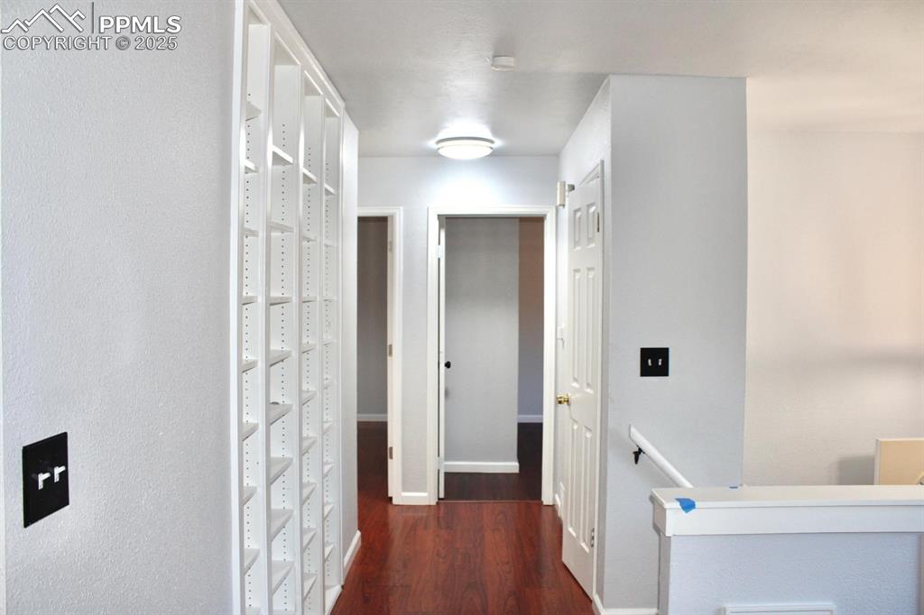 Image 5 of 15: Hall with an upstairs landing and wood finished floors
