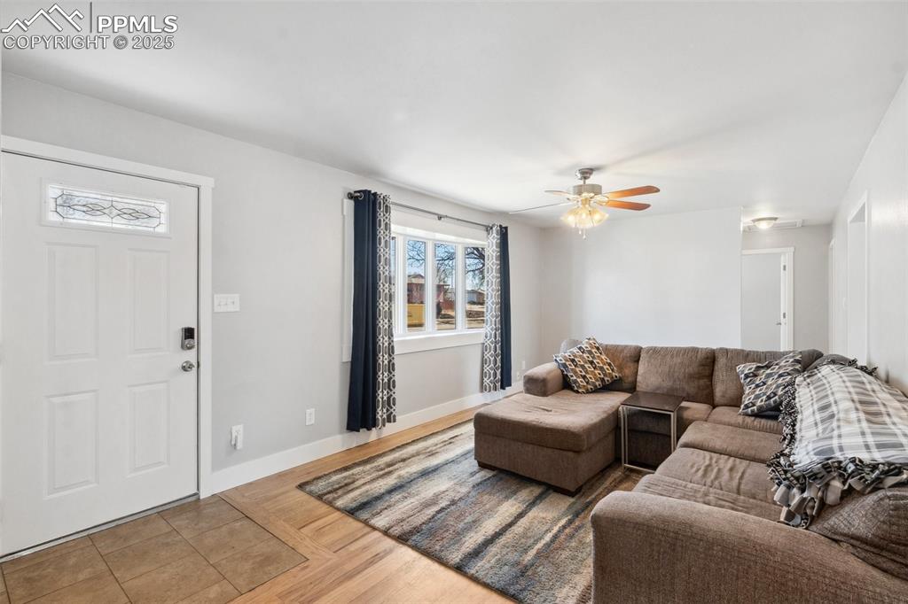 Image 4 of 17: Living room featuring wood finished floors and a ceiling fan