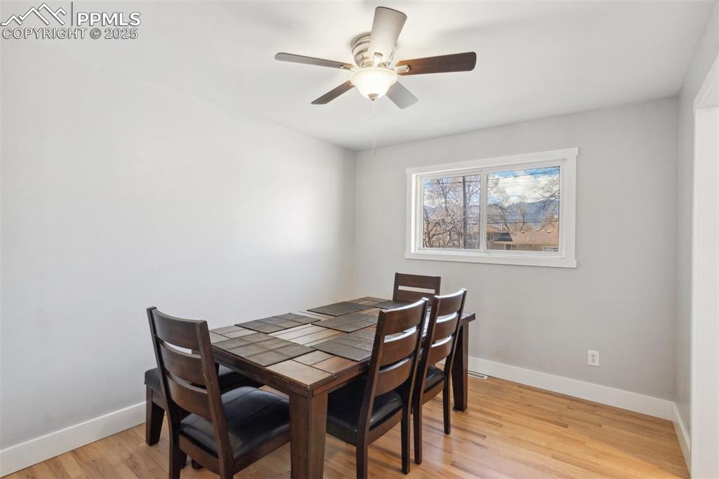 Image 5 of 17: Dining area featuring light wood-style flooring and ceiling fan