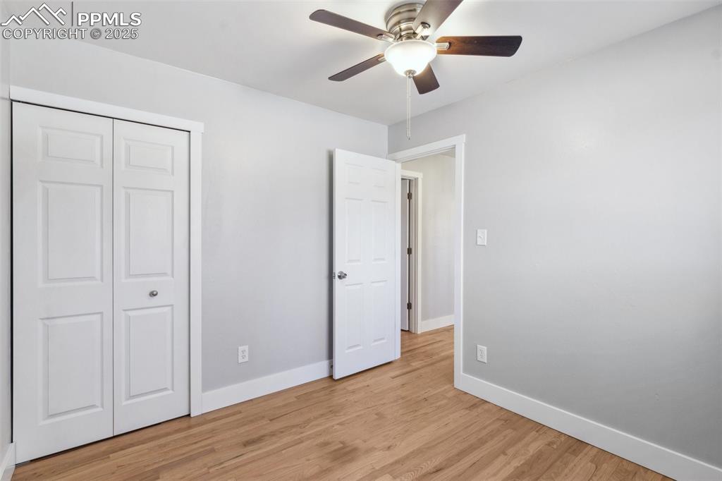 Image 9 of 17: Unfurnished bedroom with light wood-style floors, ceiling fan, and a closet