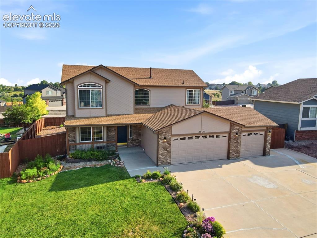 Image 1 of 40: Two-story residence featuring a three-car garage, stone accents on the faca