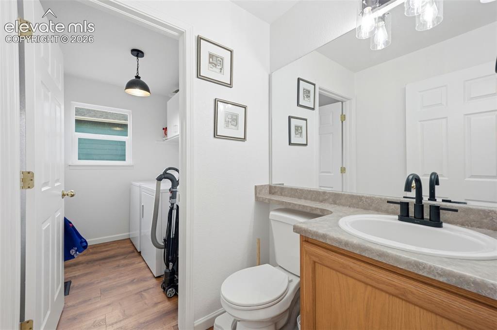 Image 14 of 40: Bathroom vanity with a composite countertop and integrated sink, complement