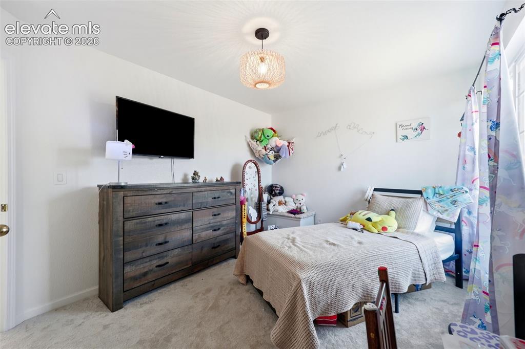 Image 18 of 40: Recessed lighting, wall-mounted television, and a neutral wall color