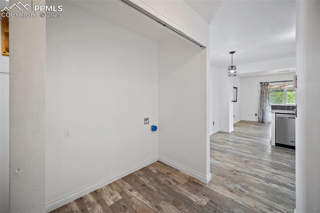 Image 24 of 50: Washroom with light wood-type flooring and baseboards