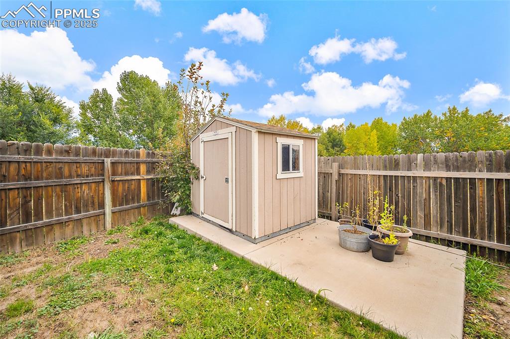 Image 49 of 50: View of shed featuring a fenced backyard